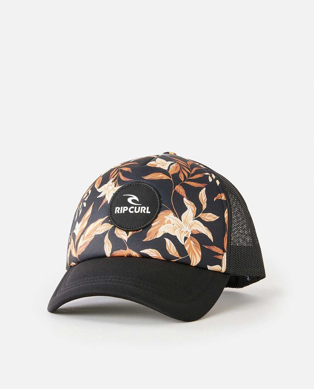 The Rip Curl La Isla Trucker features a curved peak, black mesh back, beige and brown floral pattern, and a circular Rip Curl logo patch on the front.