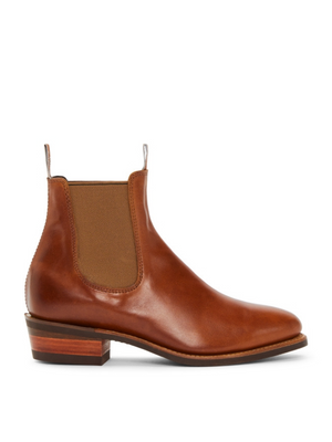 The RM Williams Lady Yearling Rubber Sole Boot is a brown leather Chelsea boot with elastic side panels, front and back pull tabs, and a low height-enhancing heel, shown in profile facing left for stylish lift.