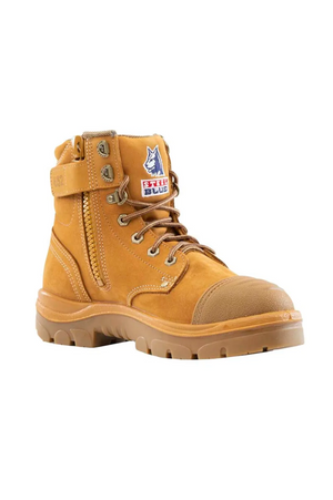 The Steel Blue Argyle Zip Scuff Cap Boot features a tan hue, rugged rubber sole, side zipper, and lace-up front. This work boot is designed with water-resistant leather, a safety steel toe, a graphic patch with text on the tongue, and a padded ankle cuff.