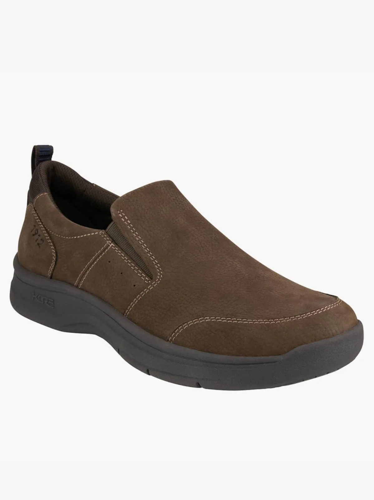 The Florsheim Mac Mocc Slip On is a brown slip-on shoe with visible white stitching, a black cushioned sole with KORE Technology, and a heel pull tab, shown on a white background.