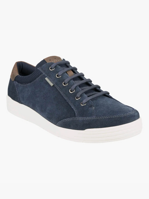 The Florsheim City Walk Lace Sneaker in navy blue has a white sole, textured fabric, brown heel accent, and Kore Technology with a Comfort Gel heel pod for support—all shown on a plain white background.