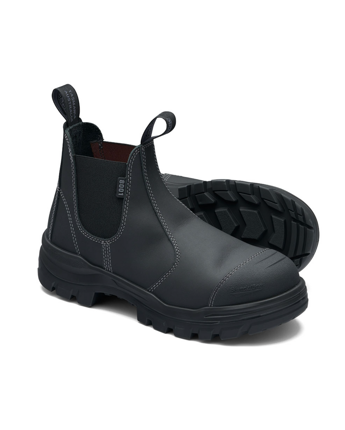 The Blundstone RotoFlex 8001 Safety Boots in black leather feature a steel toe cap, pull tabs, and thick textured rubber soles. They are displayed on a white background, with one boot upright and the other lying on its side.