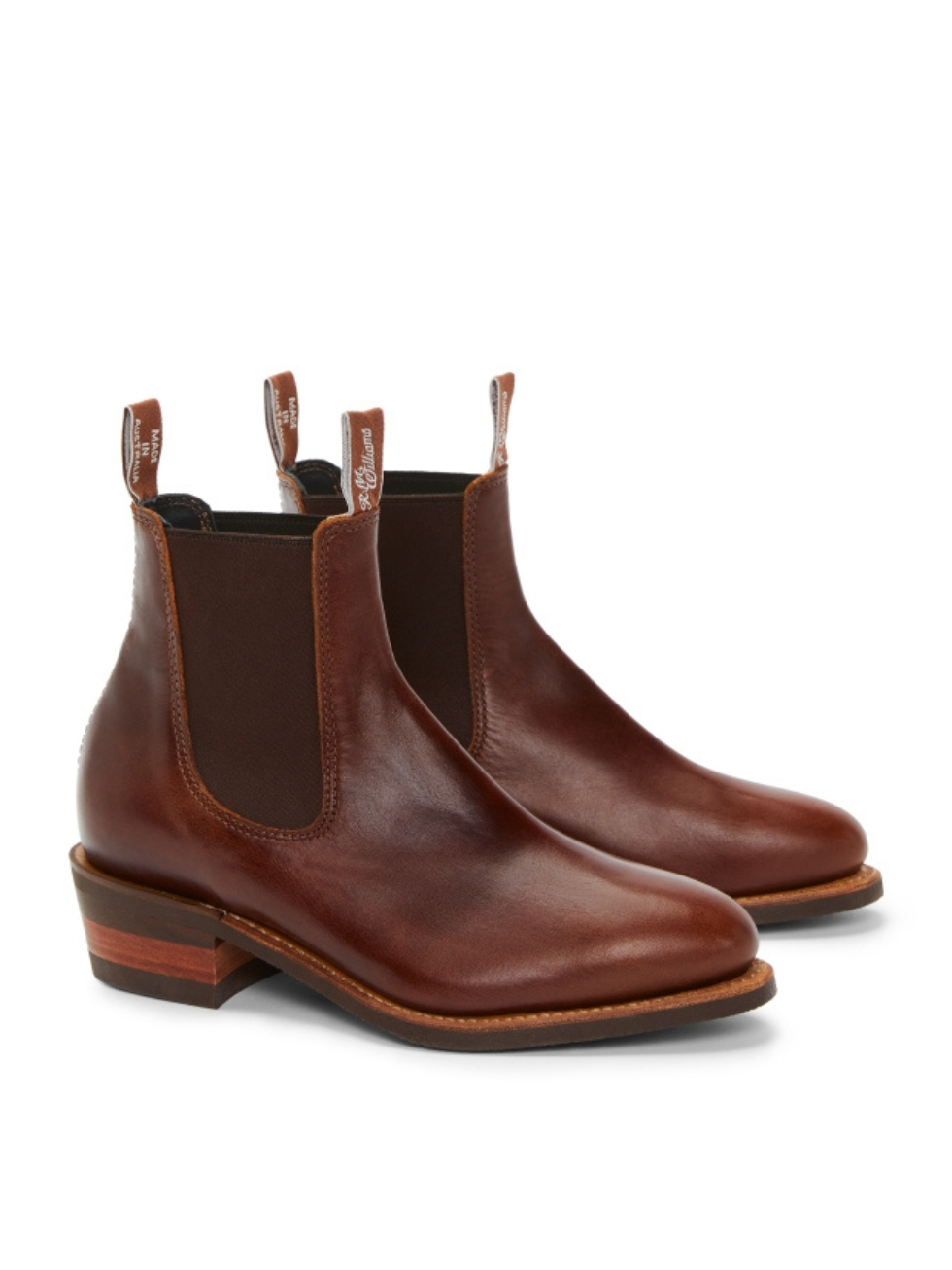 The RM Williams Lady Yearling Rubber Sole Boot, a handmade brown Chelsea for women, features elastic side panels, pull tabs, a comfort insole, a low wooden heel, and a smooth finish—all elegantly showcased against a white background.