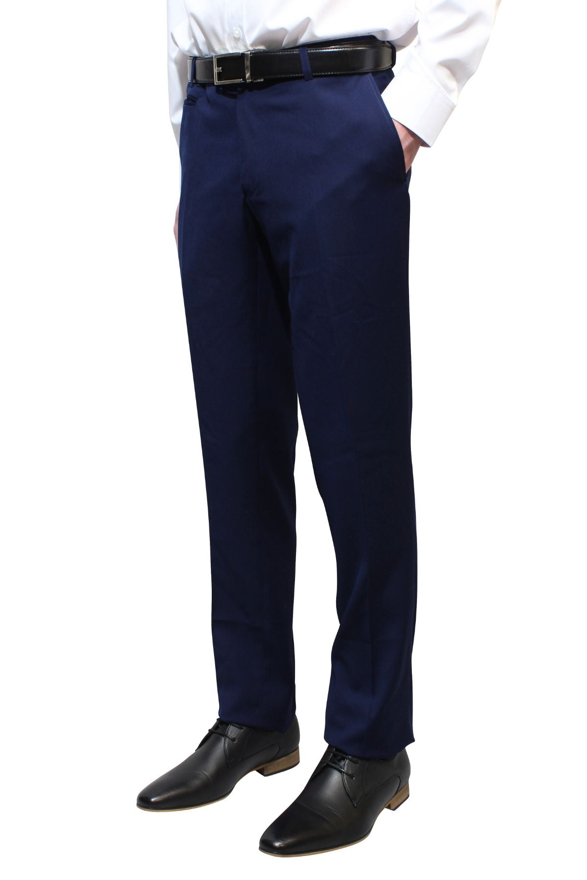 A person stands against a white background with hands in pockets, wearing Bruton Jesse Trouser (slim fit with hip pockets), a white shirt, black belt, and black dress shoes.