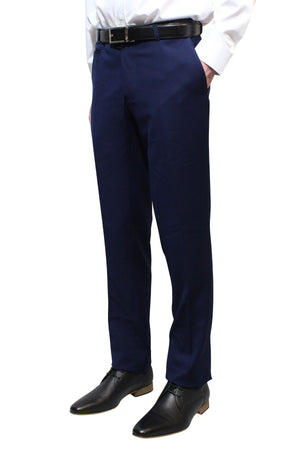 A person stands against a white background with hands in pockets, wearing Bruton Jesse Trouser (slim fit with hip pockets), a white shirt, black belt, and black dress shoes.