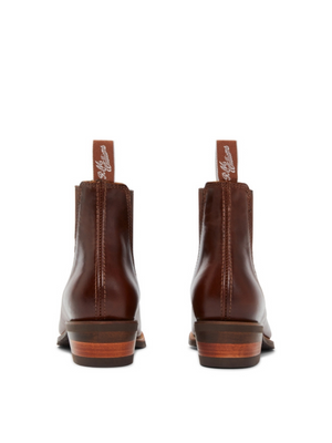 Rear view of RM Williams Lady Yearling Rubber Sole Boot in brown leather, featuring pull tabs, elastic sides, comfort insoles, and wooden heels against a white background.
