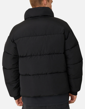 A person is seen from behind in an Industrie The Regent Puffer Jacket, black with quilted padding and a high collar, featuring horizontal stitching against a plain white background.