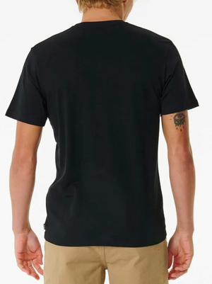 A person with blonde hair is seen from the back wearing a Rip Curl Brand Icon Tee, made of 100% cotton, paired with beige shorts. They have a tattoo of an eye with dripping detail on their left arm against a minimalist white background.