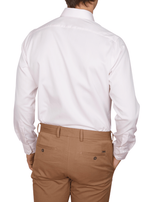 A man is seen from the back wearing an Abelard Non Iron Cotton Twill Slim Fit Shirt with a cutaway collar and tan dress pants with buttoned back pockets, standing against a plain white background.