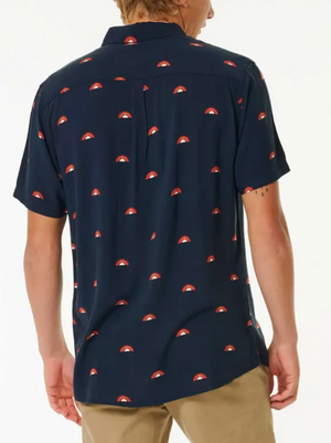 A person is seen from the back against a white background, wearing the Rip Curl Party Pack Short Sleeve Shirt in navy blue with a red and white pattern and tan pants, highlighting its stylish look and comfortable fit.