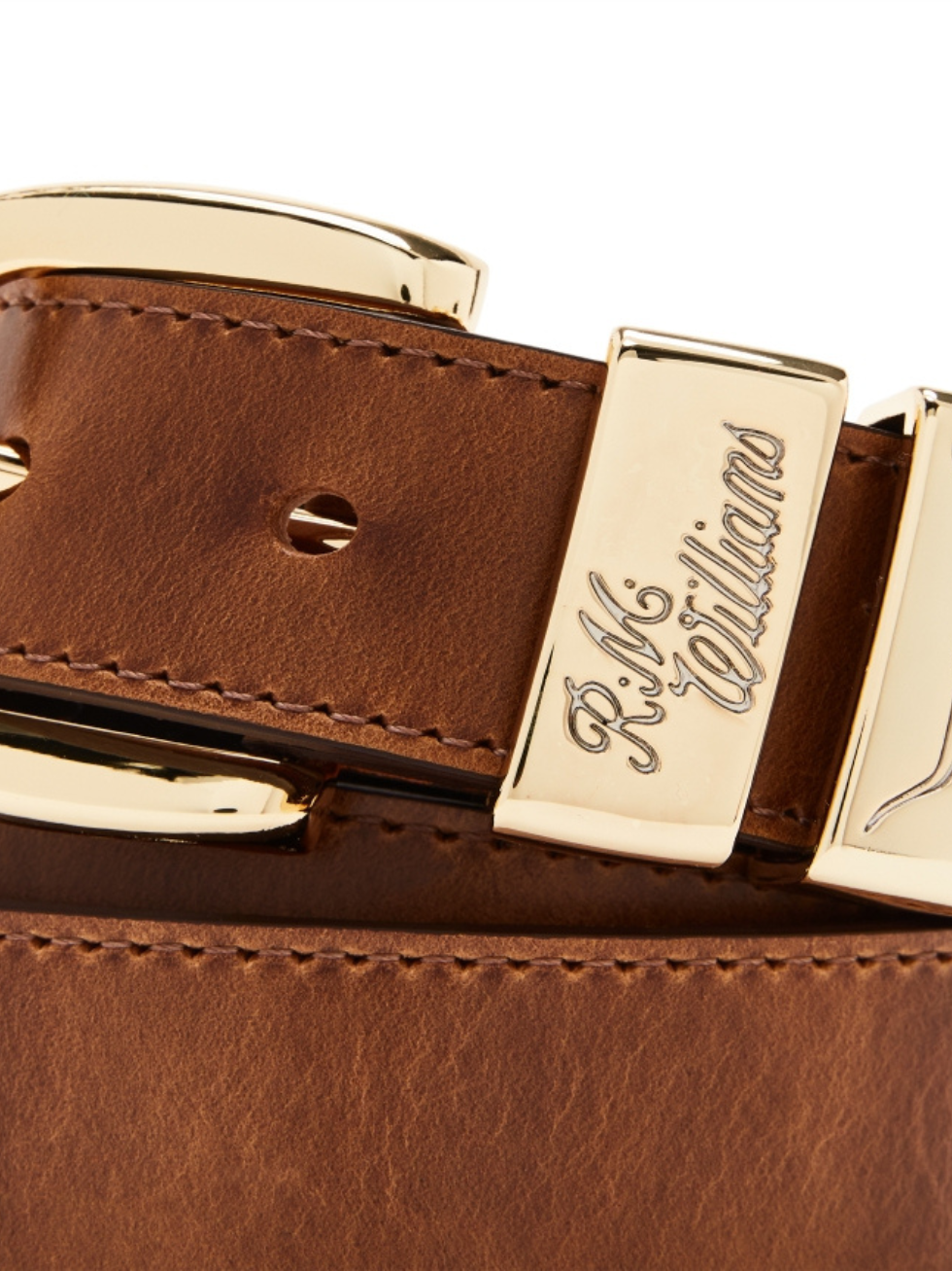 Close-up of the RM Williams Drover Belt, featuring rich pull-up leather with a shiny gold buckle engraved with "R.M. Williams." Made in Australia, the belt has a smooth texture and visible adjustment holes.