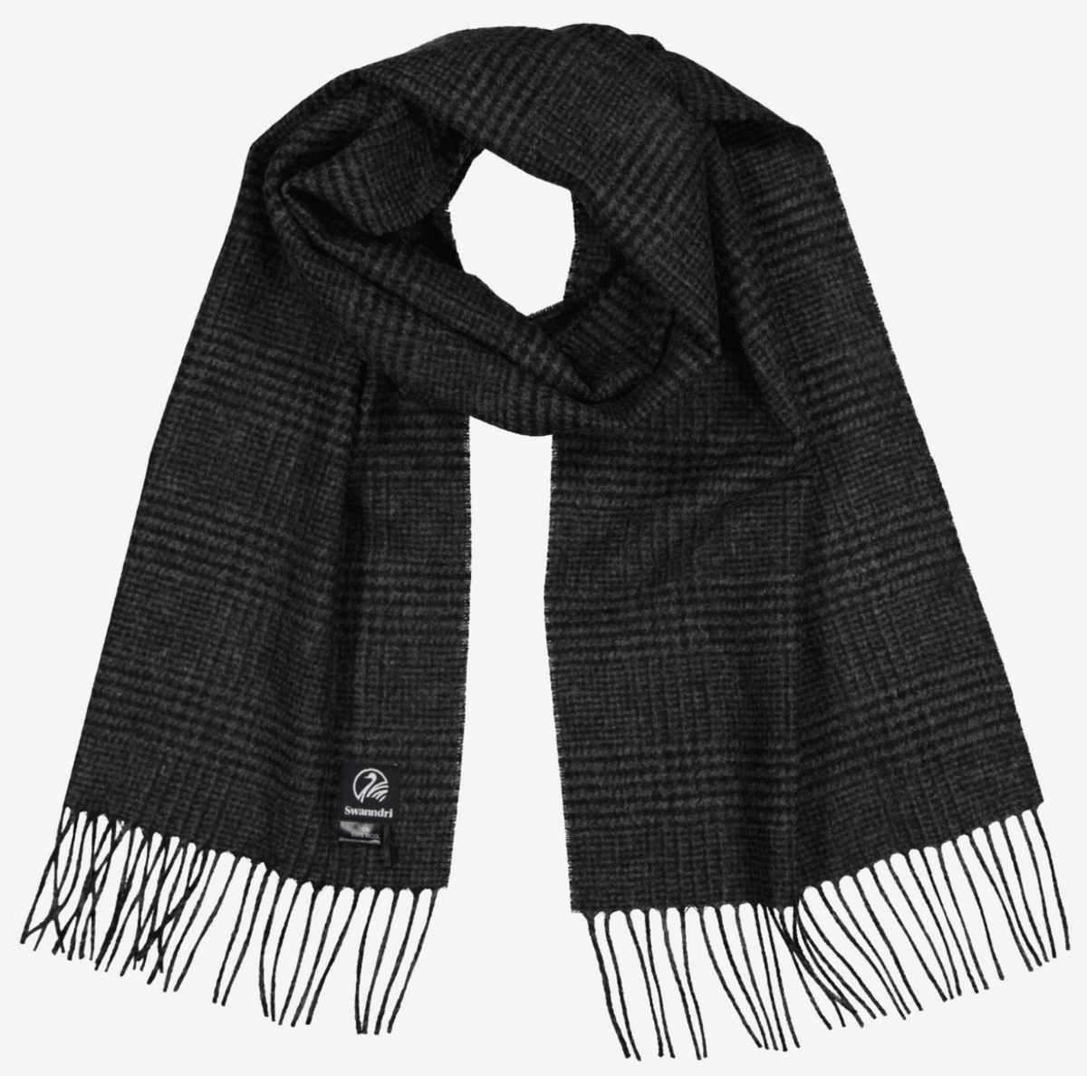 The Swanndri The Scarfie is a dark gray plaid scarf crafted from soft brushed wool with fringed ends and a small rectangular label sewn near one end, shown neatly laid out on a white background.