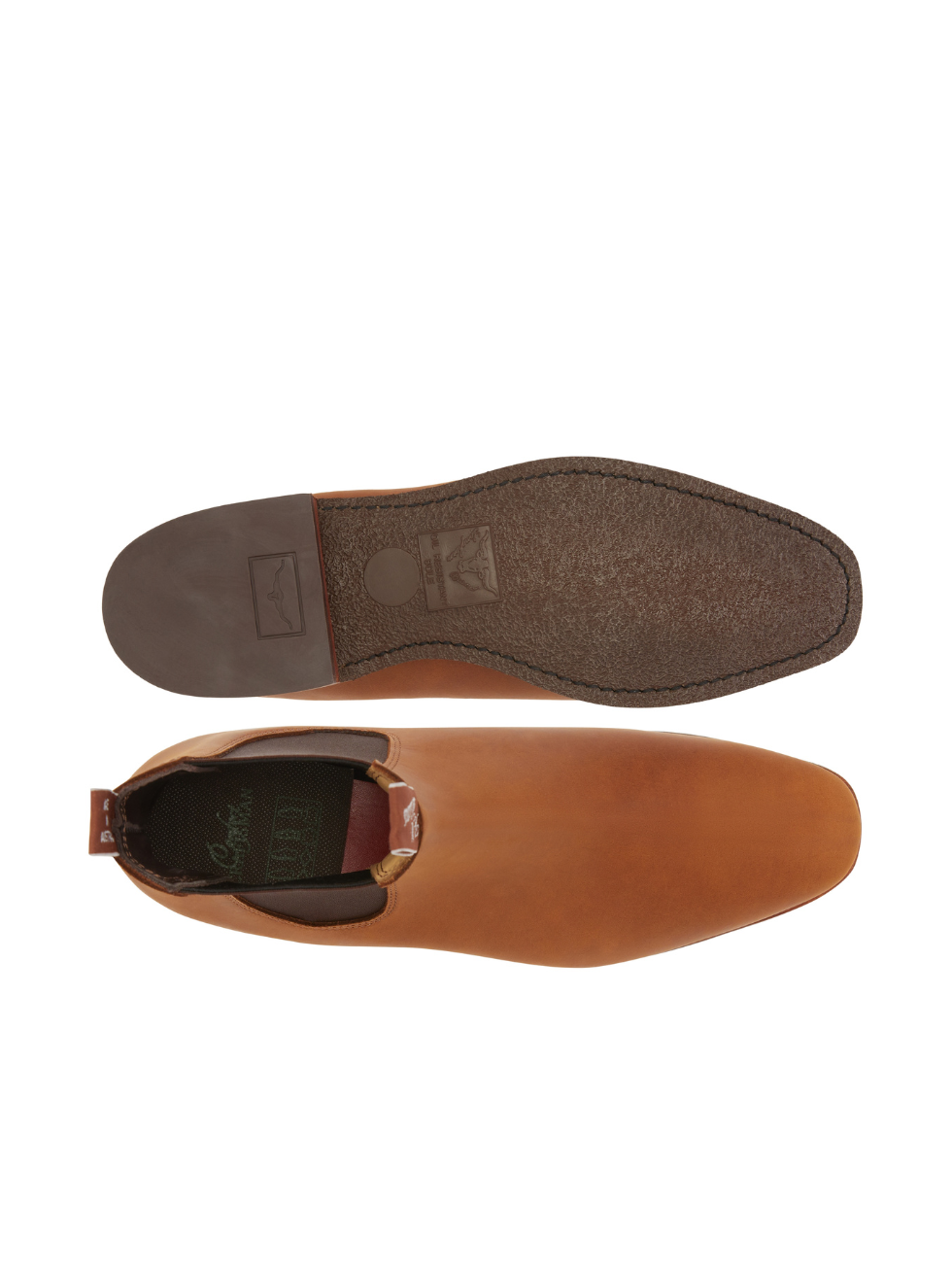 The RM Williams Comfort Craftsman Boot in tan features a sleek nubuck-style finish with one boot displaying a smooth top view, while the other reveals the textured sole pattern.
