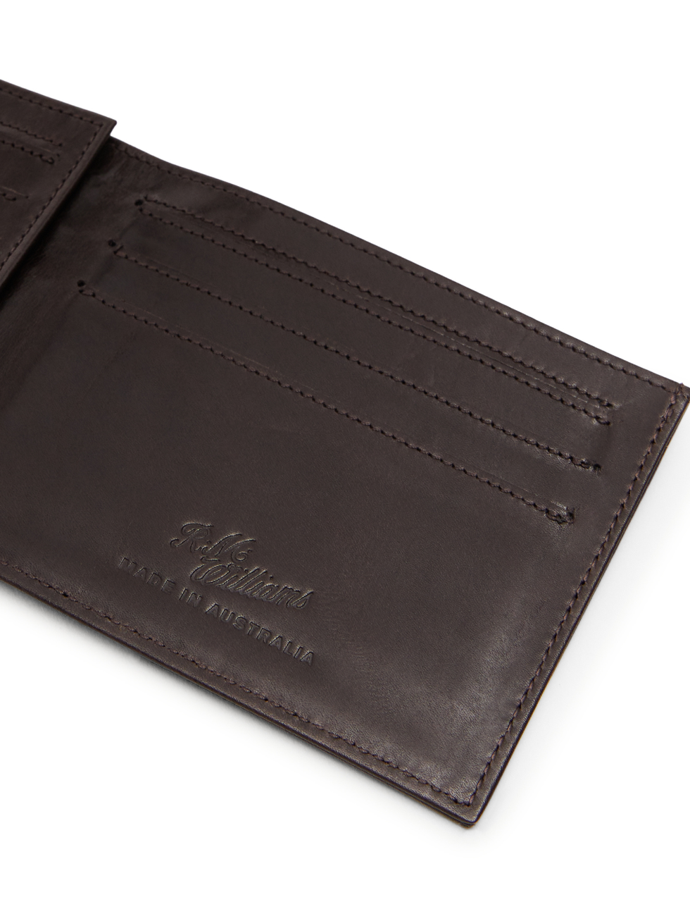 Open brown calf leather RM Williams Singleton Bi-fold Wallet displaying card slots and embossed “R. M. Williams Made in Australia” text inside.