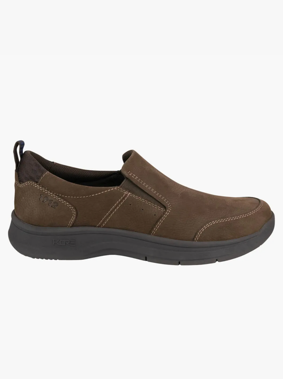 The Florsheim Mac Mocc Slip On is a brown slip-on casual shoe with contrast stitching, KORE Technology for comfort, a black heel pull tab, and a thick dark gray cushioned sole that blends classic style with modern design.