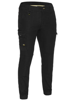 The Bisley Flex & Move Stretch Denim Cargo Cuffed Pant features Cordura durability, multiple pockets, a button and zipper closure, belt loops, and elastic ankle cuffs.