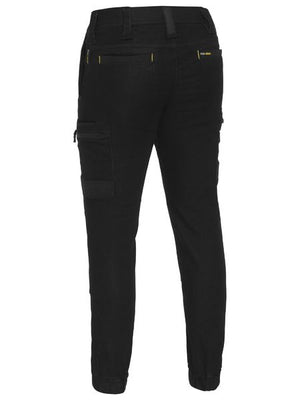 Back view of Bisley Flex & Move Stretch Denim Cargo Cuffed Pant in black shows visible stitching, side cargo pockets, and belt loops at the waist. Crafted from stretch knit denim, the fabric is sturdy and designed for functionality with multiple pockets.