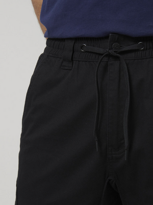 A close-up of a person wearing Hard Yakka Tough Maxx Pant drawstring pants and a navy blue shirt, highlighting the waistband and upper leg—perfect for those seeking durable, comfortable workwear.