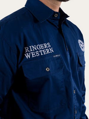 A person wears a dark blue Ringers Western Hawkeye Embroidered Shirt with two chest pockets and “RINGERS WESTERN” in white on the left; their face is not visible.