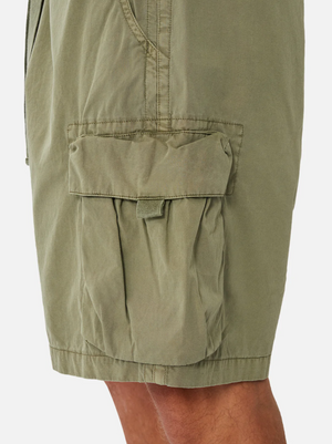 Close-up of the Industrie The Del Sur Combat Short in olive green, featuring a flap pocket with Velcro closure. Visible stitching and creases create a rugged look. Made from 100% cotton with multiple pockets, it’s styled to show a glimpse of the wearer's leg.