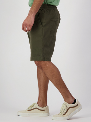 The lower torso and legs of a person are shown as they face left, wearing Swanndri Clevedon Stretch Canvas Short with a comfortable elastic waist, set against a plain white background.