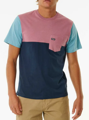 Wearing a Rip Curl Surf Revival Custom Tee—100% cotton with light blue sleeves, pink upper and pocket, dark blue lower section—paired with khaki shorts.