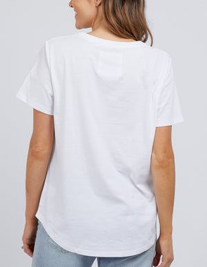 Rear view of someone with long hair in a relaxed-fit Foxwood Tee and light blue jeans. The plain white T-shirt is crafted from 100% cotton, set against a neutral background that highlights the outfit's simplicity.