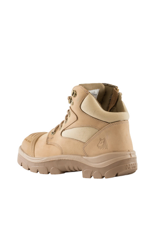 The Steel Blue Parkes Zip Scuff Cap Boot is a tan, high-ankle boot featuring metal eyelets and matching tan laces. It boasts a rugged, textured sole for superior traction, a heat-resistant outsole, and an embossed wolf head logo on the side. The boot's padded ankle collar and tongue enhance comfort, while the safety steel toe provides additional protection.