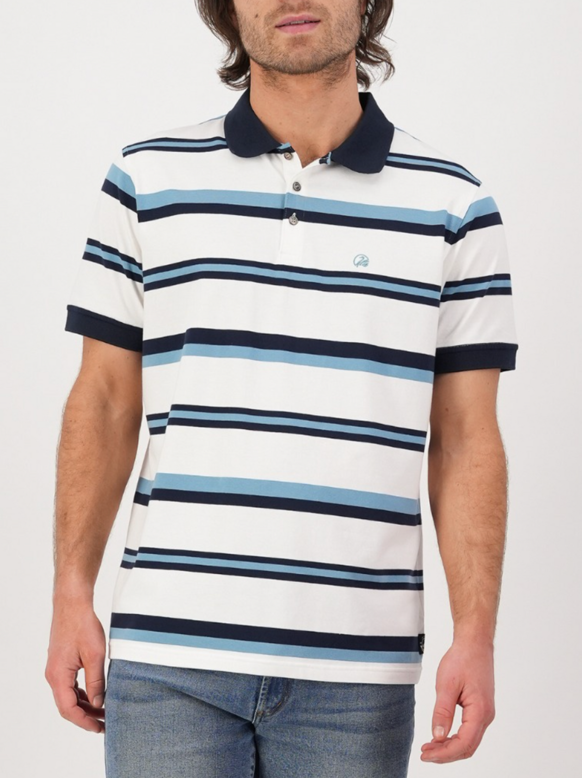 A person is wearing the Swanndri Winfred Stripe Polo with blue and black stripes, teamed with blue jeans. Set against a plain white background, the polo showcases a short collar and an embroidered Swanndri logo on the left side.