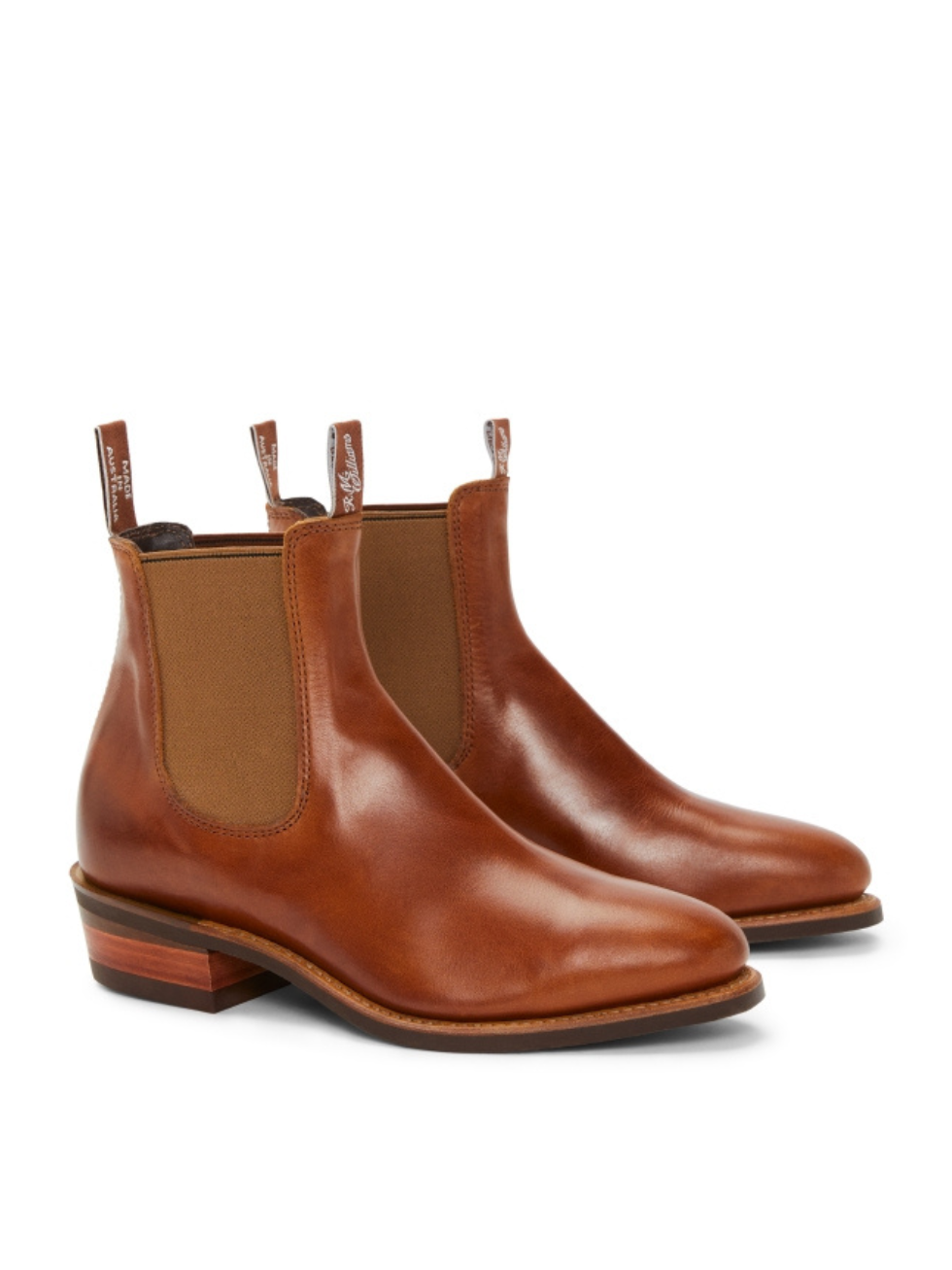 The RM Williams Lady Yearling Rubber Sole Boot, in brown leather with tan elastic side panels, pull tabs, and a height-enhancing heel, is shown against a white background.