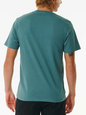 A person with short blond hair is seen from behind, wearing a teal Rip Curl Plain Pocket Tee (100% cotton) and black shorts. A small tattoo appears on their left upper arm. The background is plain white.