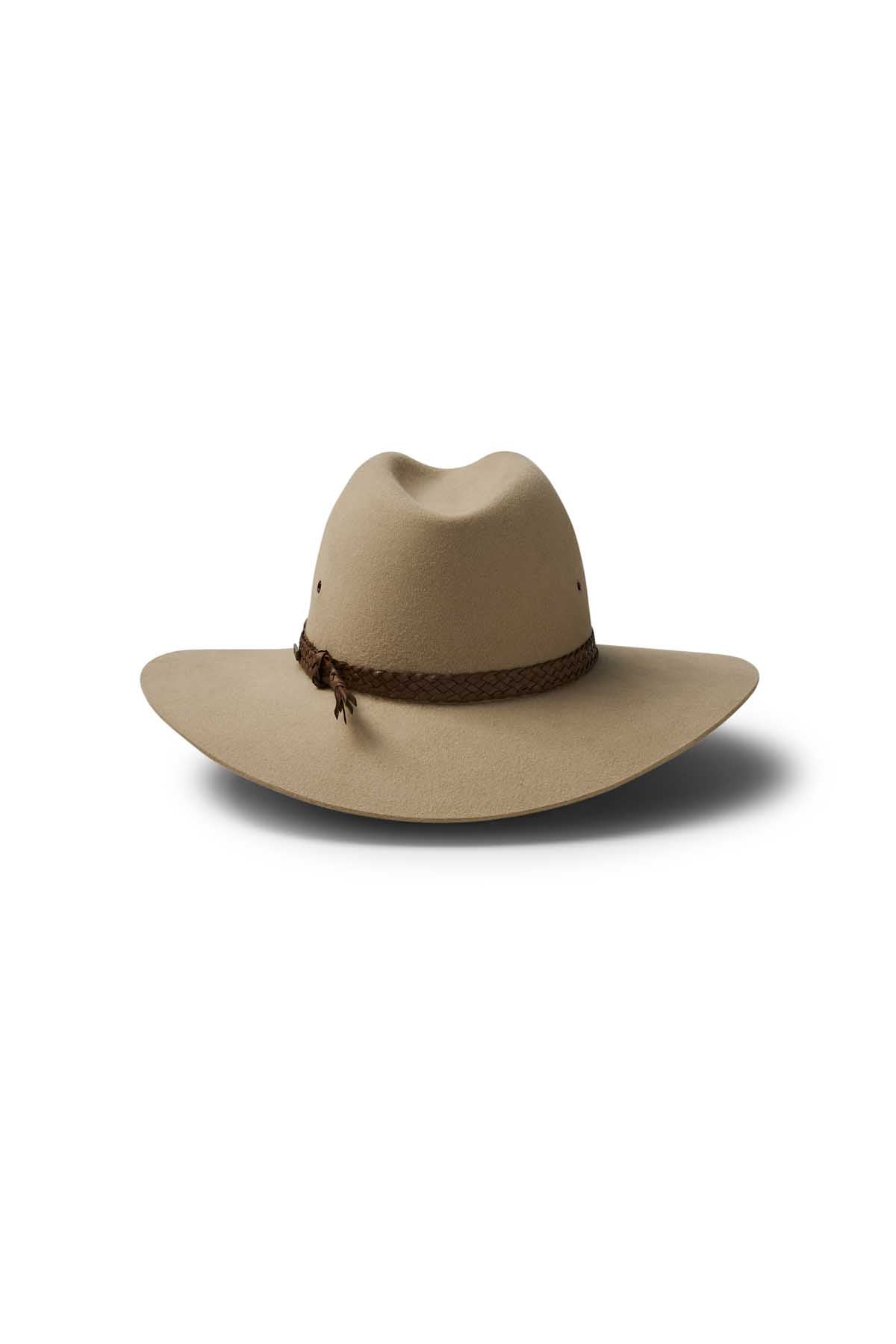 The Akubra Riverina is a wide-brimmed, light brown cowboy hat with a creased crown, braided brown band, and comfortable leather sweatband, shown on a white background with a soft shadow.