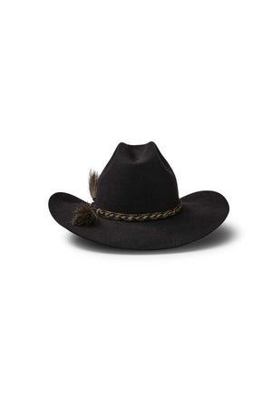 A black Akubra Rough Rider hat with a Cattleman crown, featuring a brown braided band and a small feather on the left side, set against a white background.