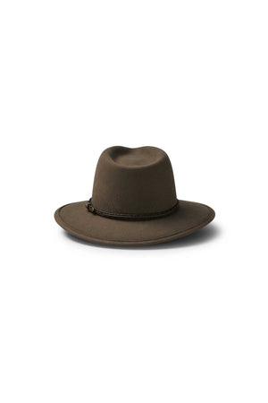 The Akubra Traveller is a brown, wide-brimmed felt hat with a creased crown and braided leather band, shown on a white background.