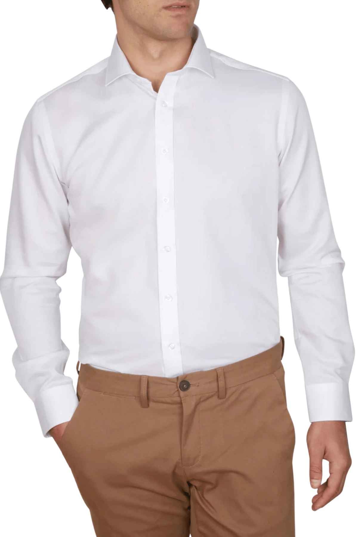 A person wears an Abelard Non Iron Cotton Twill Super Slim Fit Shirt, paired with light brown pants. The shirt's distinct cuffs and collar are visible, while their left hand rests casually in a pocket. The face is not shown.