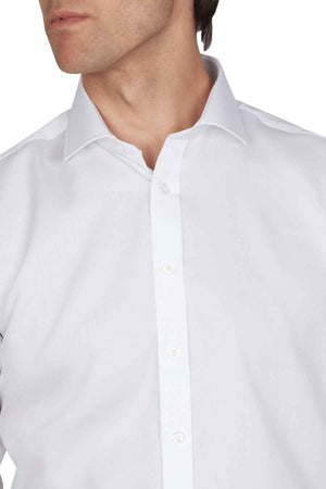 A man wears an Abelard Non Iron Cotton Twill Super Slim Fit Shirt, featuring a spread collar. The image highlights the upper torso and collar, with his head partially visible, slightly turned to the side.