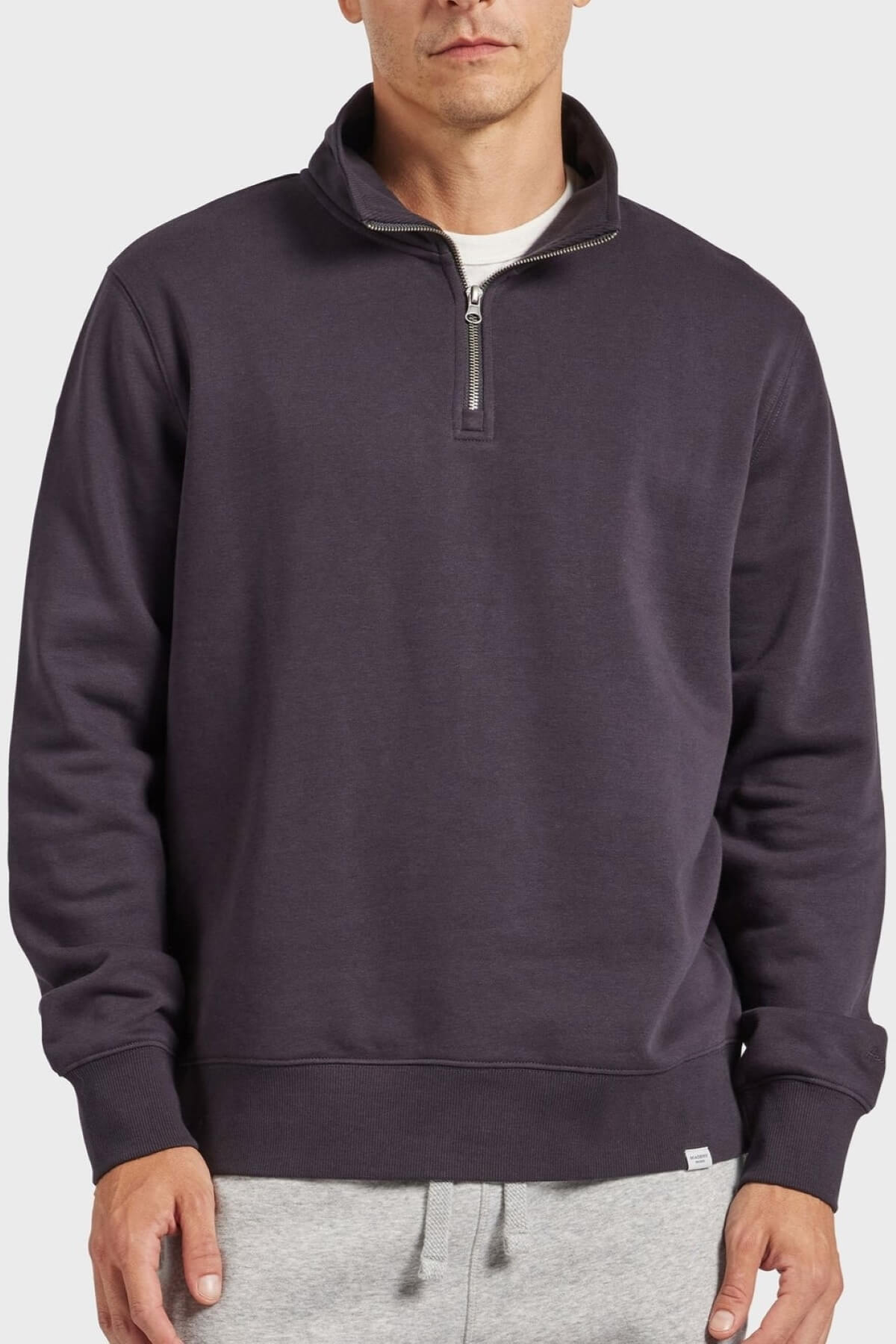 A man wearing the Academy Brand 1/2 Zip Sweat over a white T-shirt and light gray sweatpants, standing against a plain background.