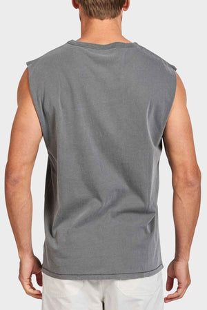 A man is seen from the back wearing the Academy Brand Jimmy Muscle Tee, crafted from 100% cotton, paired with white shorts against a plain background.