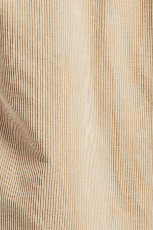 Close-up image of the Academy Brand Lebowski Cord Overshirt, showcasing its mid-weight corduroy fabric with distinctive vertical ridges and soft texture. The 100% cotton material exhibits a slight drape, forming gentle folds and shadows, making it ideal for crafting a stylish shirt.