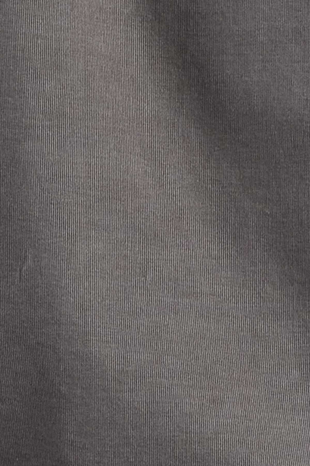 Close-up of the Academy Brand Micro Cord Shirt in dark grey 100% cotton with a smooth, fine, and slightly wavy surface. The texture suggests it might be a type of woven fabric. The lighting creates subtle light and dark gradients, enhancing its polished look.