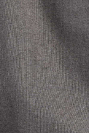 Close-up of the Academy Brand Micro Cord Shirt in dark grey 100% cotton with a smooth, fine, and slightly wavy surface. The texture suggests it might be a type of woven fabric. The lighting creates subtle light and dark gradients, enhancing its polished look.
