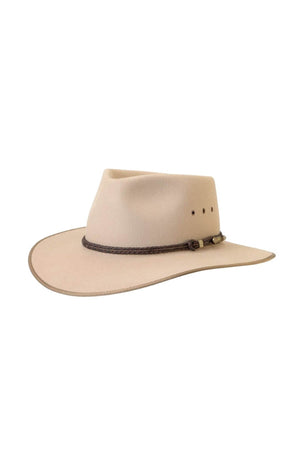 The Akubra Cattleman is a beige cowboy hat with a wide brim, brown braided band with metal accents, and ventilation holes on the sides, reflecting classic Cattleman style and Australian identity.