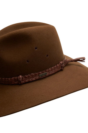 The Akubra Riverina is a brown wide-brimmed hat featuring a braided leather band, small metal tag, and side eyelets for ventilation—an ideal Australian farming hat that offers excellent sun protection.