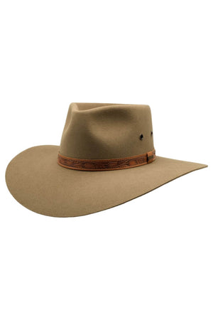 An Akubra Territory Hat in tan, featuring a wide brim with a subtle crease on the crown and a brown leather band wrapped around it. Resembling the iconic styles of the Australian Outback, the braided design of the band is complemented by small ventilation holes on the sides of the crown.