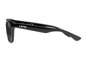 Side view of children's-sized black Liive Alvin sunglasses with a glossy finish. The frames have thick arms with "LIVNE" and model text in white, providing UV protection. These stylish shades are perfect for kids on sunny days.