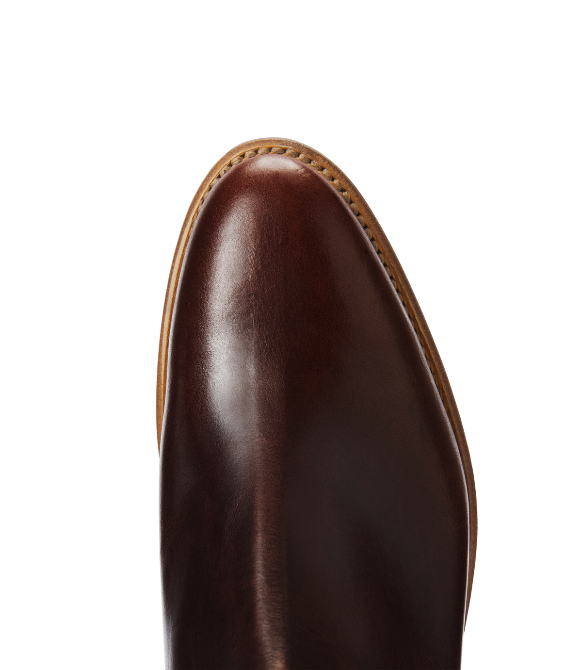 Close-up of the toe of the RM Williams Moriarty Rubber Sole Boot, featuring polished brown pull-up leather with visible stitching along the tan sole, set against a white background.