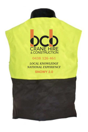 The BCB Crane Hire Hi Vis Oilskin Vest features high-visibility yellow and black design, "OCO Crane Hire & Construction," phone number, "Local Knowledge National Experience," and "SNOWY 2.0" on the back. Complies with AS/NZS 4602.1 standards.