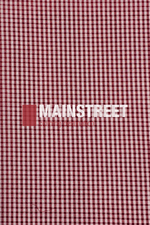 A red and white checkered fabric pattern, inspired by the Bisley Countryman Seersucker Short Sleeve Shirt, featuring "MAINSTREET" printed in bold white letters across the center.