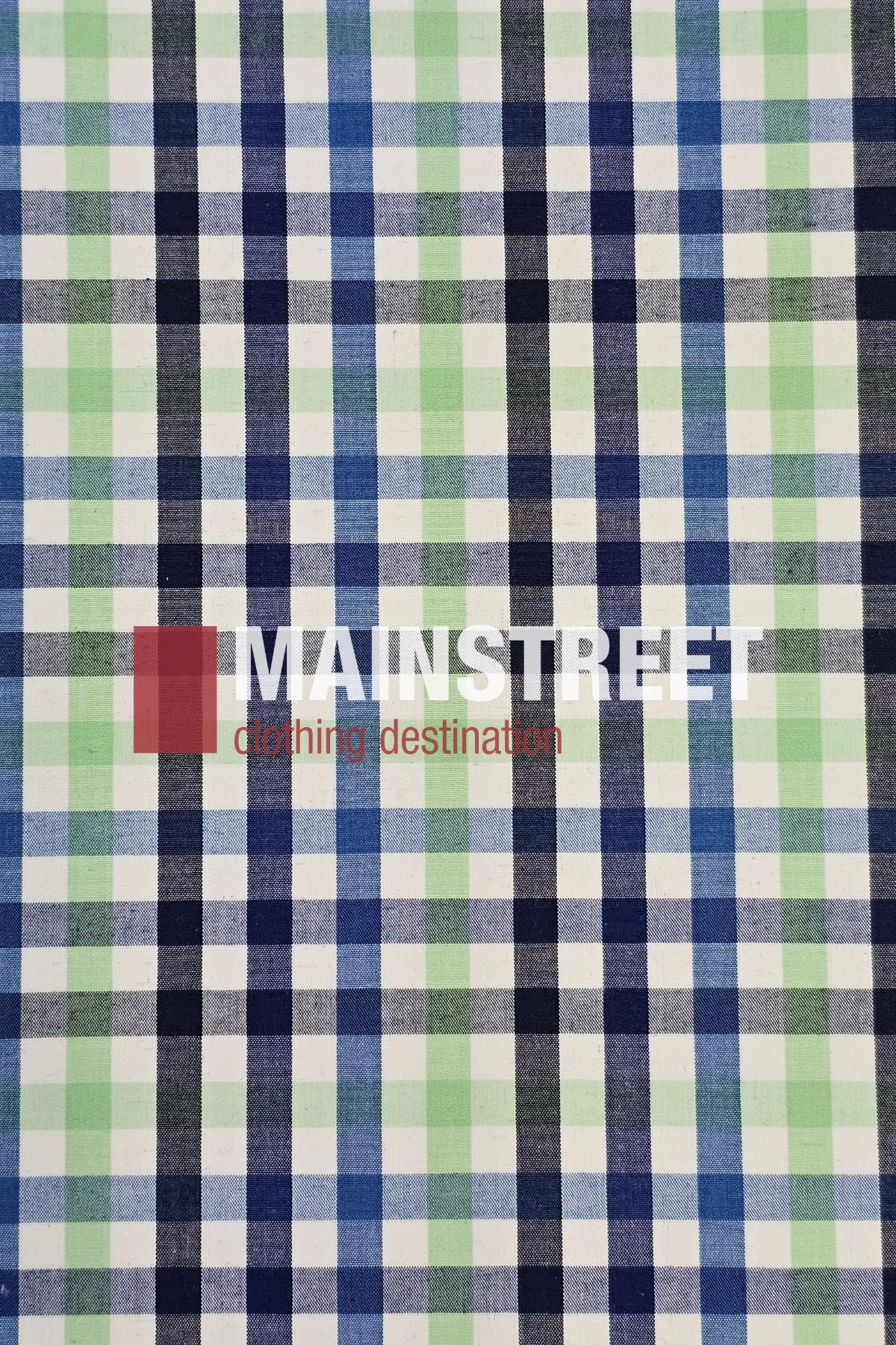 Inspired by the Bisley Countryman Shirt, this checkered fabric features green, blue, and white squares with "MAINSTREET clothing destination" printed over it in white and red letters.