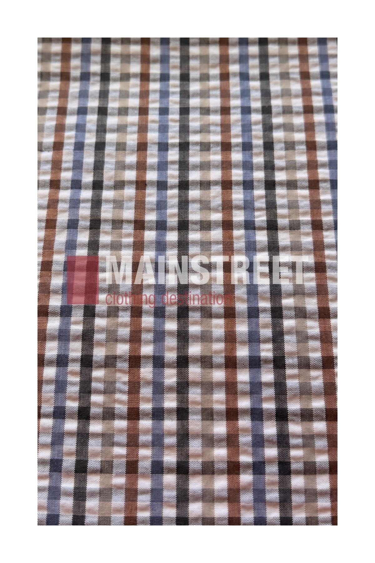 A checkered fabric pattern featuring brown, blue, and gray stripes channels the classic style of the Bisley Countryman Seersucker Short Sleeve Shirt. The phrase “MAINSTREET clothing destination” appears faintly across the fabric.